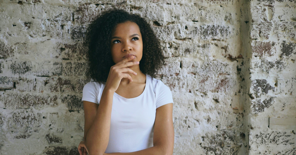 Woman thinking about the difference between “passed” and “past”.