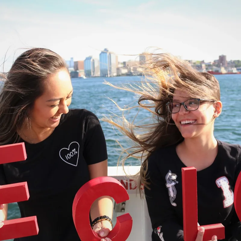 Students hold ECLC logo