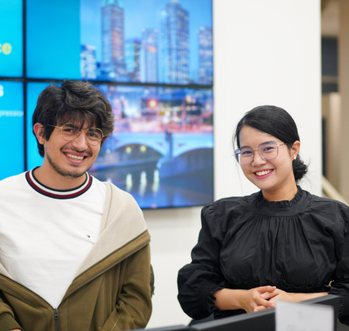 Students smiling as they pose for a photo