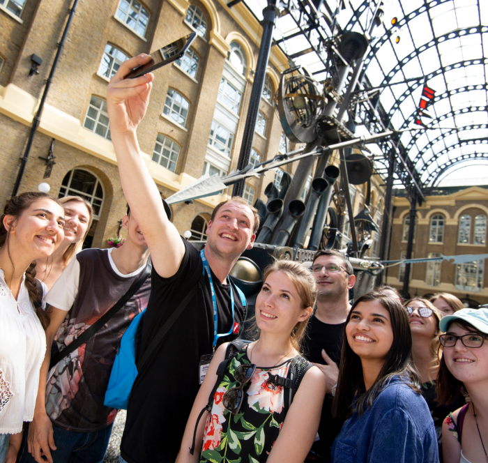Students taking a selfie inside Greenwich Market in London Greenwich. Experience immersive English language learning through Oxford International's social programme.
