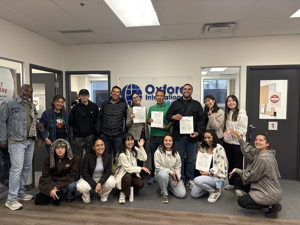Toronto students celebrating graduation from a General English course after improving their speaking skills through classroom practice, teacher guidance, and interactive English lessons.